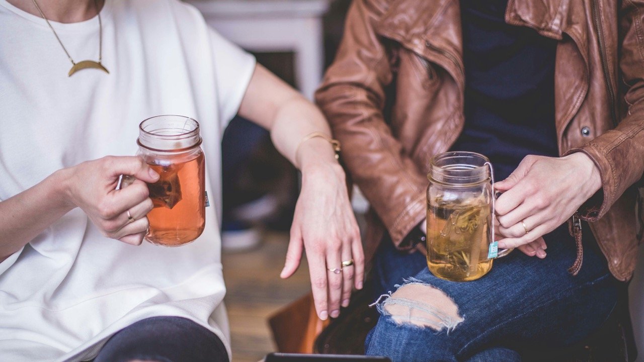couple with cups of tea