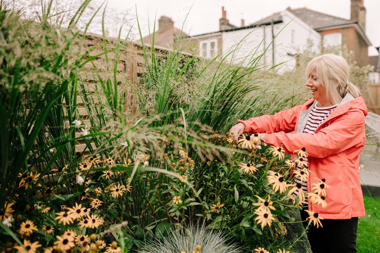 A woman tending flowers in her garden